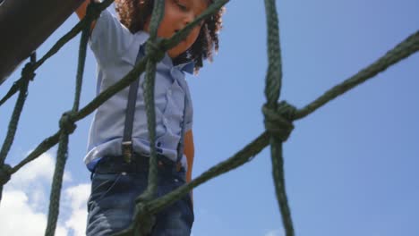 Low-angle-view-of-mixed-race-schoolgirl-playing-in-school-playground-on-a-sunny-day-4k
