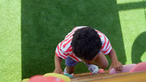 High-angle-view-of-African-American-schoolboy-playing-in-school-playground-on-a-sunny-day-4k