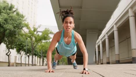 Front-view-of-young-African-American-woman-exercising-in-the-city-4k