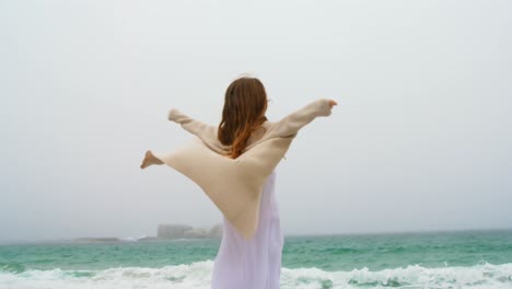 Young-Caucasian-woman-dancing-on-the-beach-4k
