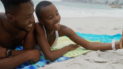 Front-view-of-African-american-couple-taking-selfie-with-mobile-phone-on-the-beach-4k