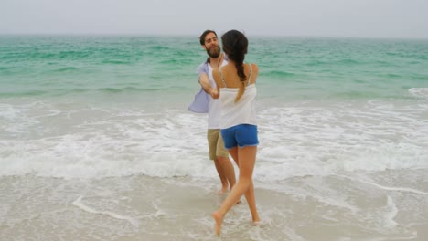Caucasian-couple-having-fun-together-on-the-beach-4k