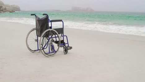 Empty-wheelchair-at-beach-on-a-sunny-day-4k