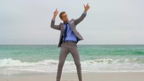 Front-view-of-Caucasian-Businessman-dancing-on-the-beach-4k