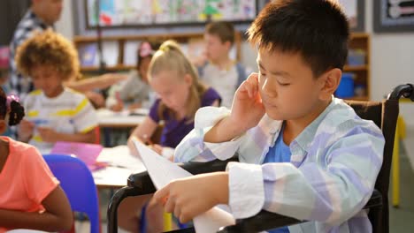 Front-view-of-Disabled-Asian-schoolboy-studying-in-the-classroom-4k-
