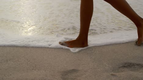 Low-section-of-woman-walking-on-the-beach-4k