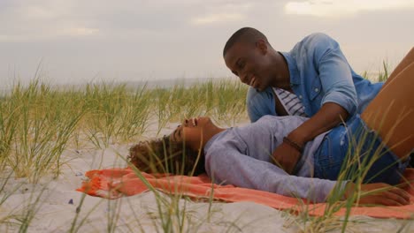 Side-view-of-African-american-couple-having-fun-on-the-beach-4k
