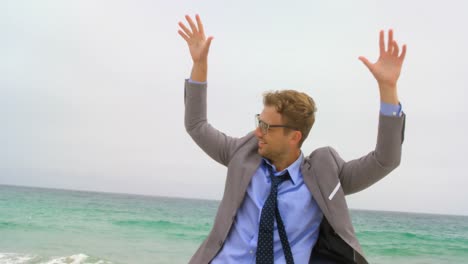Front-view-of-Caucasian-Businessman-dancing-on-the-beach-4k