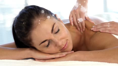 Masseuse-doing-massage-to-smiling-caucasian-patient-
