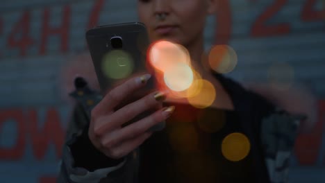 Woman-using-mobile-phone-surrounded-by-bokeh-effect