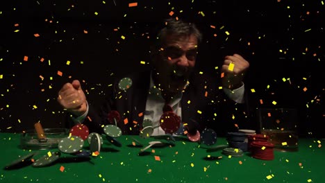 Casino-winner-sitting-at-casino-table-while-tokens-and-confetti-falling-on-table-in-slow-motion