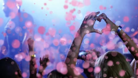 Girl-doing-heart-with-her-hands-to-singer-at-concert-with-bubble-animation
