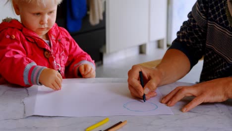 Father-helping-his-daughter-drawing-at-home-4k