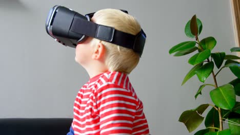Boy-using-virtual-reality-headset-in-living-room-4k