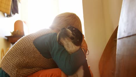 Boy-embracing-his-pet-dog-at-home-4k