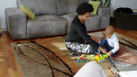 Mother-and-son-playing-with-building-blocks-in-a-comfortable-home-4k