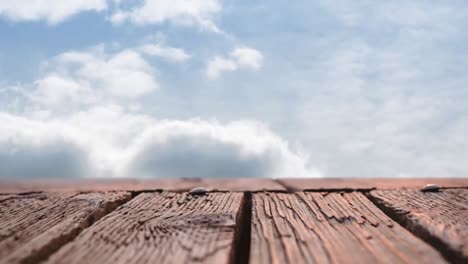 Wooden-deck-and-sky-with-clouds