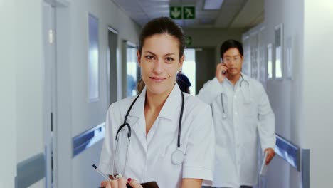 Female-doctor-standing-in-the-corridor-at-hospital-4k