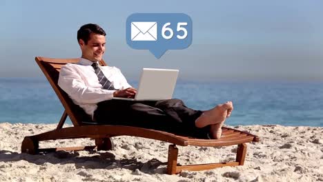Businessman-using-a-laptop-while-lounging-by-the-beach