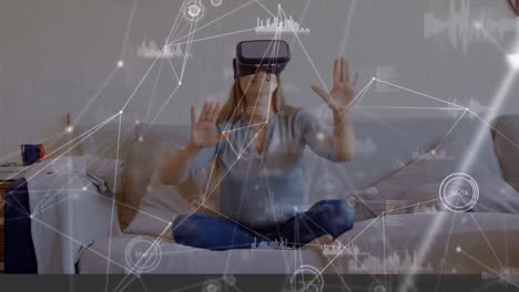 Woman-sitting-on-a-couch-wearing-a-virtual-reality-headset