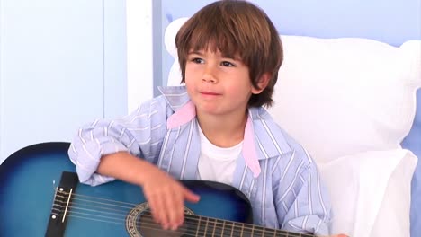 Entzückender-Kleiner-Junge,-Der-Gitarre-Spielt