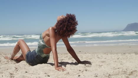 Side-view-of-young-African-american-woman-relaxing-on-the-beach-4k