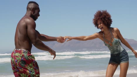 Couple-dancing-together-on-beach-in-the-sunshine-4k