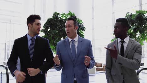 Businessmen-interacting-with-each-other-in-the-lobby-at-office-4k
