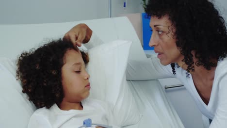Front-view-of-African-american-mother-talking-with-her-son-in-ward-at-hospital-4k