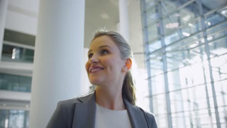 Businesswoman-smiling-in-the-lobby-at-office-4k