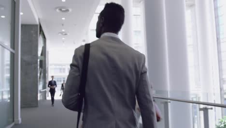 Businessman-walking-in-the-corridor-at-office-4k
