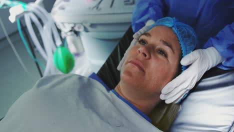 Close-up-of-Caucasian-pregnant-woman-lying-on-surgical-bed-in-operation-theater-4k