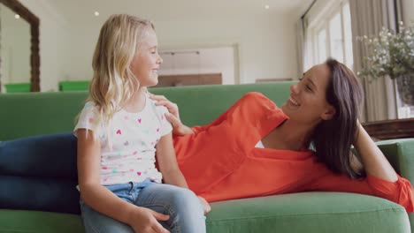 Mother-and-daughter-interacting-with-each-other-on-sofa-at-home-4k