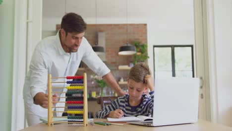 Father-helping-his-son-in-homework-at-home-4k