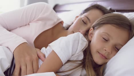 Mother-and-daughter-sleeping-on-bed-in-bedroom-at-home-4k
