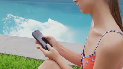 Woman-in-swimwear-using-mobile-phone-in-the-backyard-4k