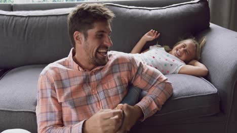 Father-and-daughter-playing-together-on-sofa-at-home-4k
