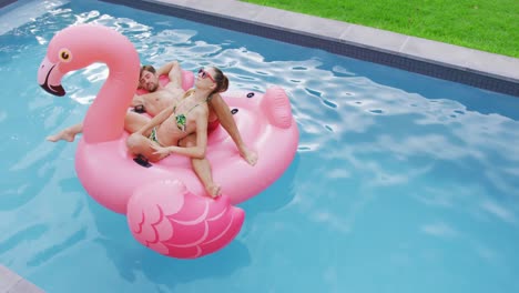 Couple-sleeping-together-on-inflatable-tube-in-swimming-pool-4k