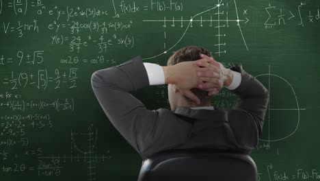 Man-in-front-of-moving-maths-on-blackboard-4k