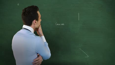 Back-view-of-man-thinking-in-front-of-moving-maths-calculations-on-chalkboard-4k