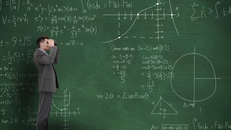 Man-in-front-of-moving-maths-on-blackboard