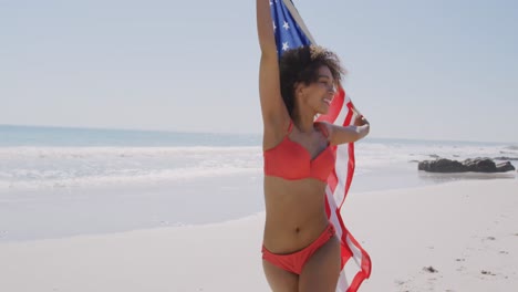Young-woman-dancing-with-flag-on-the-beach-4k