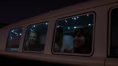 Group-of-friends-laughing-in-a-camper-van-4k