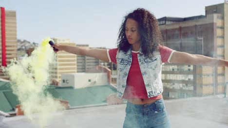 Fashionable-young-woman-on-urban-rooftop-using-a-smoke-grenade