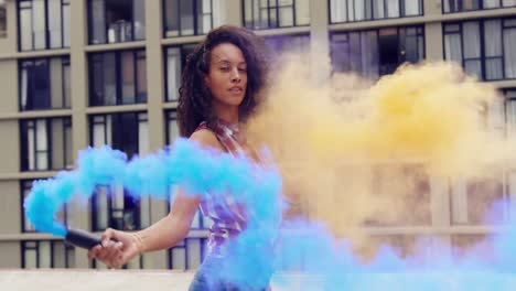 Fashionable-young-woman-on-urban-rooftop-using-smoke-grenades