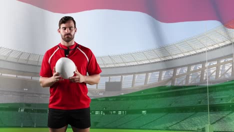 Professional-rugby-player-standing-in-front-of-a-flag-and-stadium