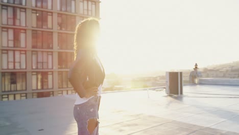 Fashionable-young-woman-on-urban-rooftop