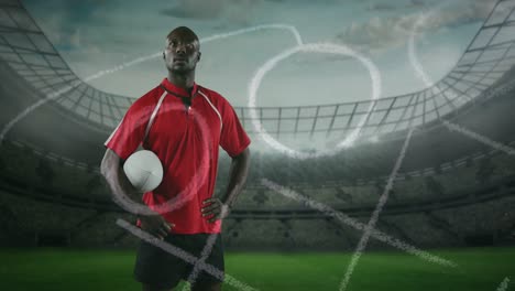 Animation-of-position-plan-over-african-american-man-with-rugby-ball-at-stadium
