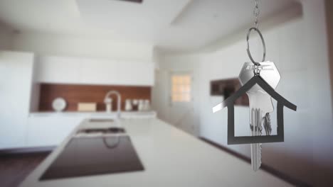 House-keys-and-key-fob-hanging-over-out-of-focus-kitchen-4k