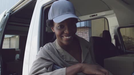 Portrait-of-young-female-van-driver-with-a-warehouse-delivery